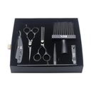 Set of black hairdressing tools including scissors, comb, and other accessories in a black box on a white background.