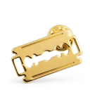 Gold double edge razor blade label pin shown on a white background