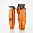 StyleCraft Saber 2 cordless hair clipper and matching Saber detail trimmer in metallic orange standing side-by-side on a plain white studio background