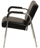 A modern Black shampoo chair armchair with a chrome tubular metal frame and legs, shown from a three-quarters angle on a white background.